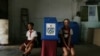 Dos niños custodian la urna en un colegio electoral de La Habana durante el referendo constitucional, el 24 de febrero de 2019. (Reuters/Fernando Medina).